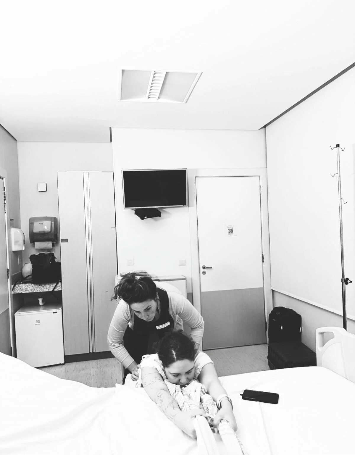 Valentina beside a new mother and her baby